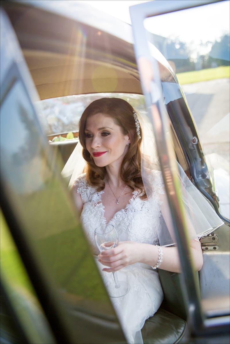 bride in vintage car arriving at her Cliff at Lyons wedding in Kildare