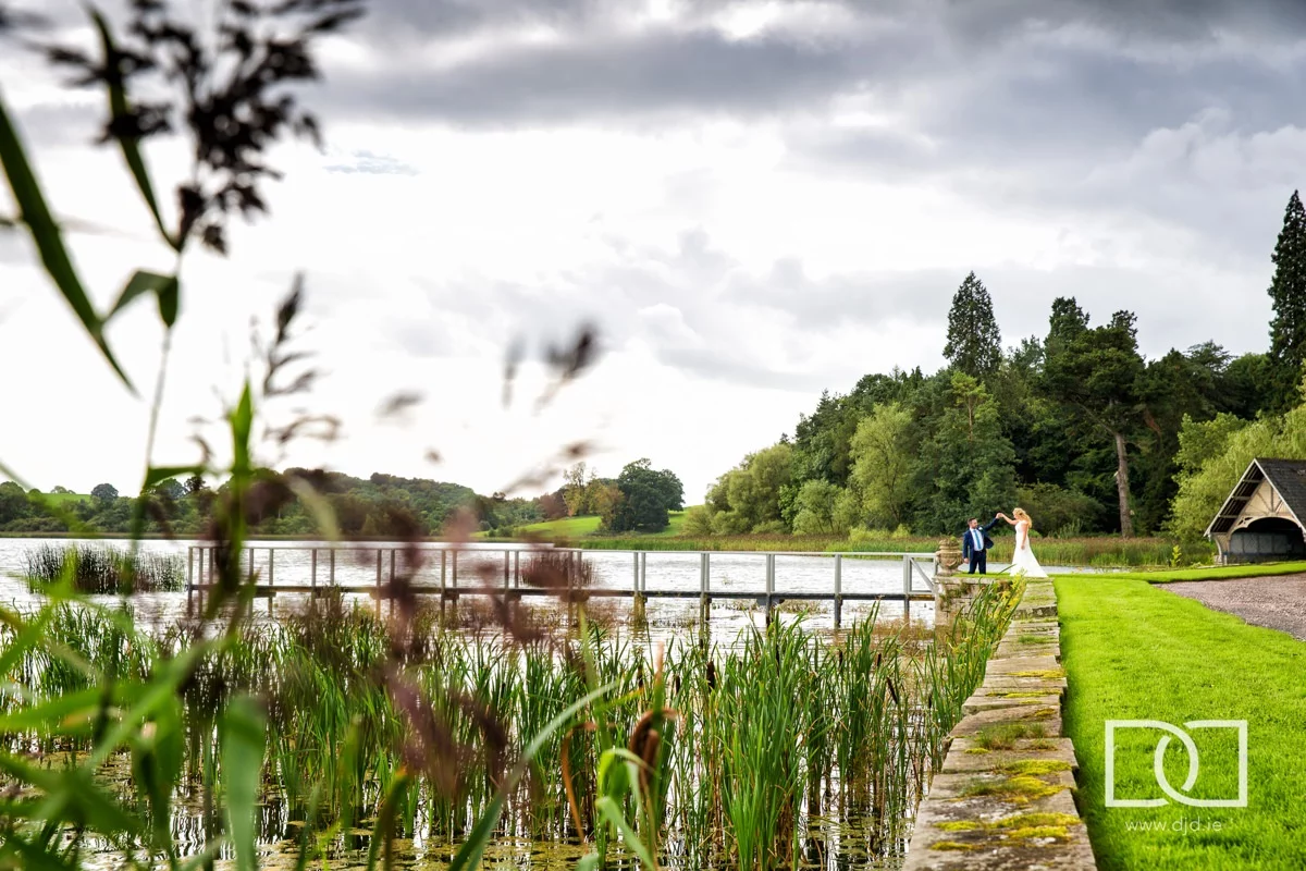 bride and groom walking on pier at their wedding at castle leslie co monaghan