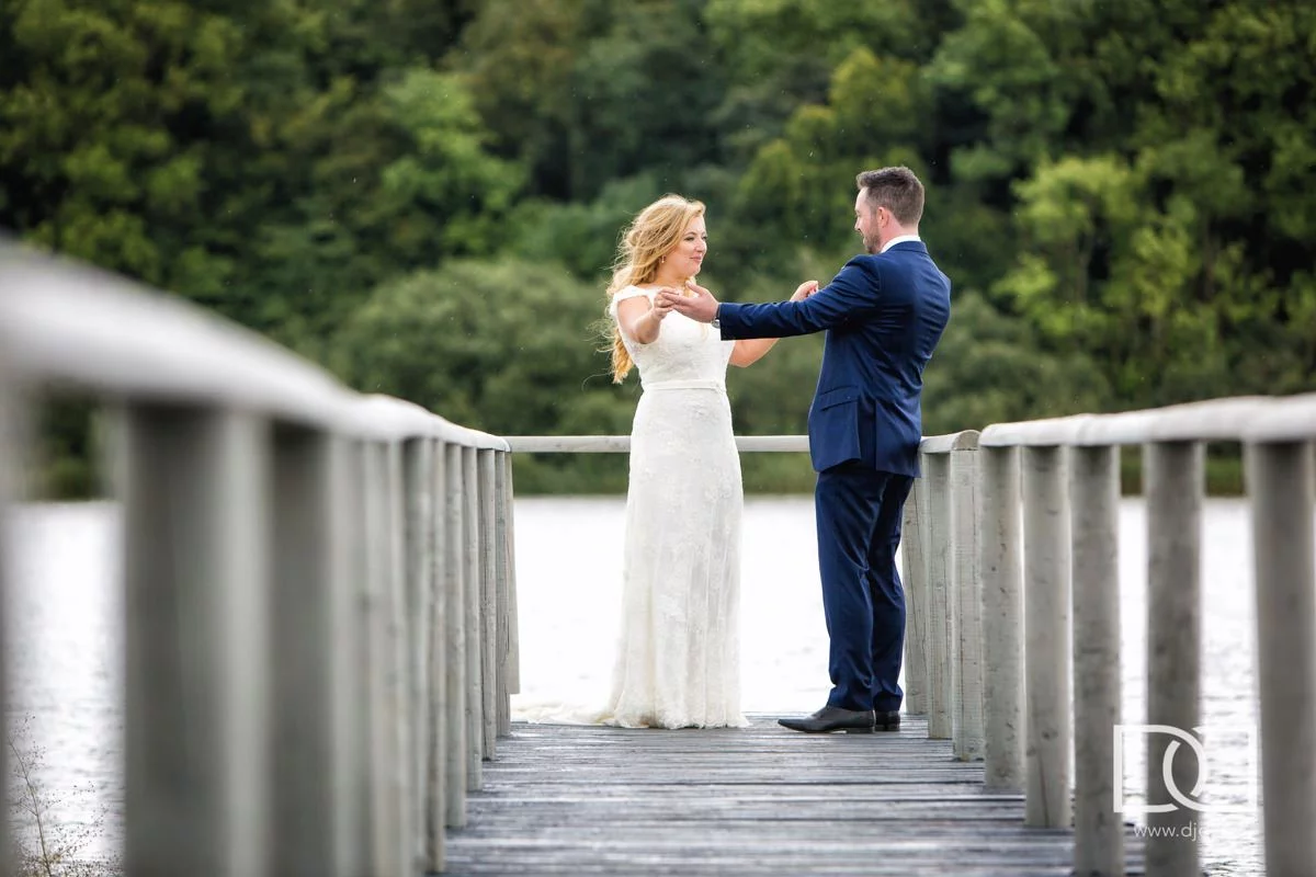 bride and groom standing on jetty at theirwedding at castle leslie co monaghan