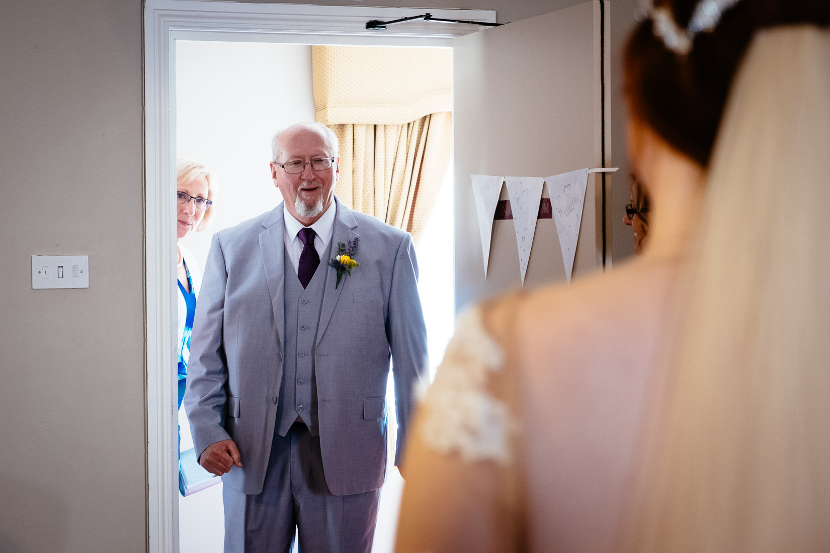 father seeing his daughter in a wedding dress for the first time