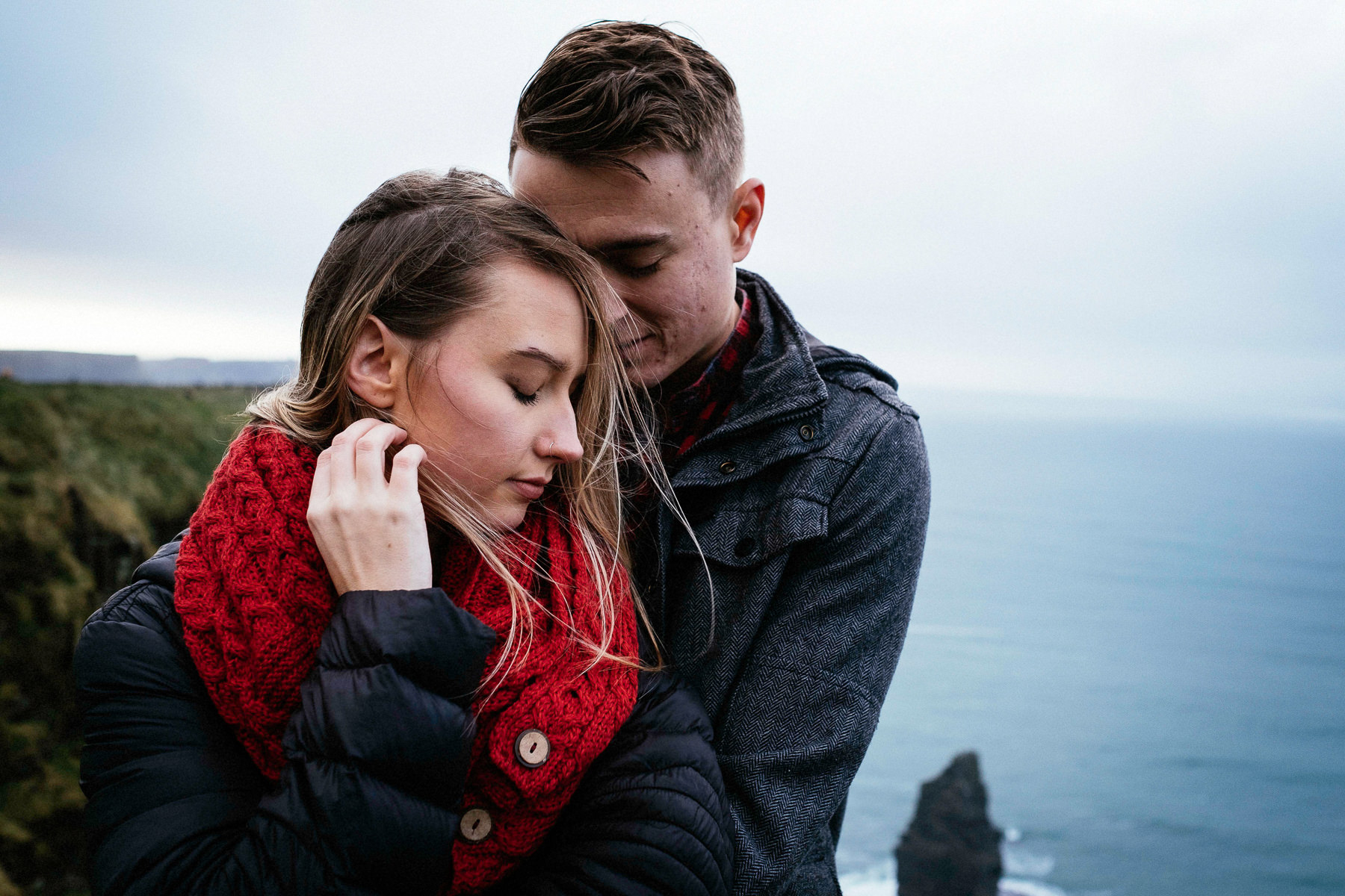 engaged couple hugging at the Cliffs of Moher