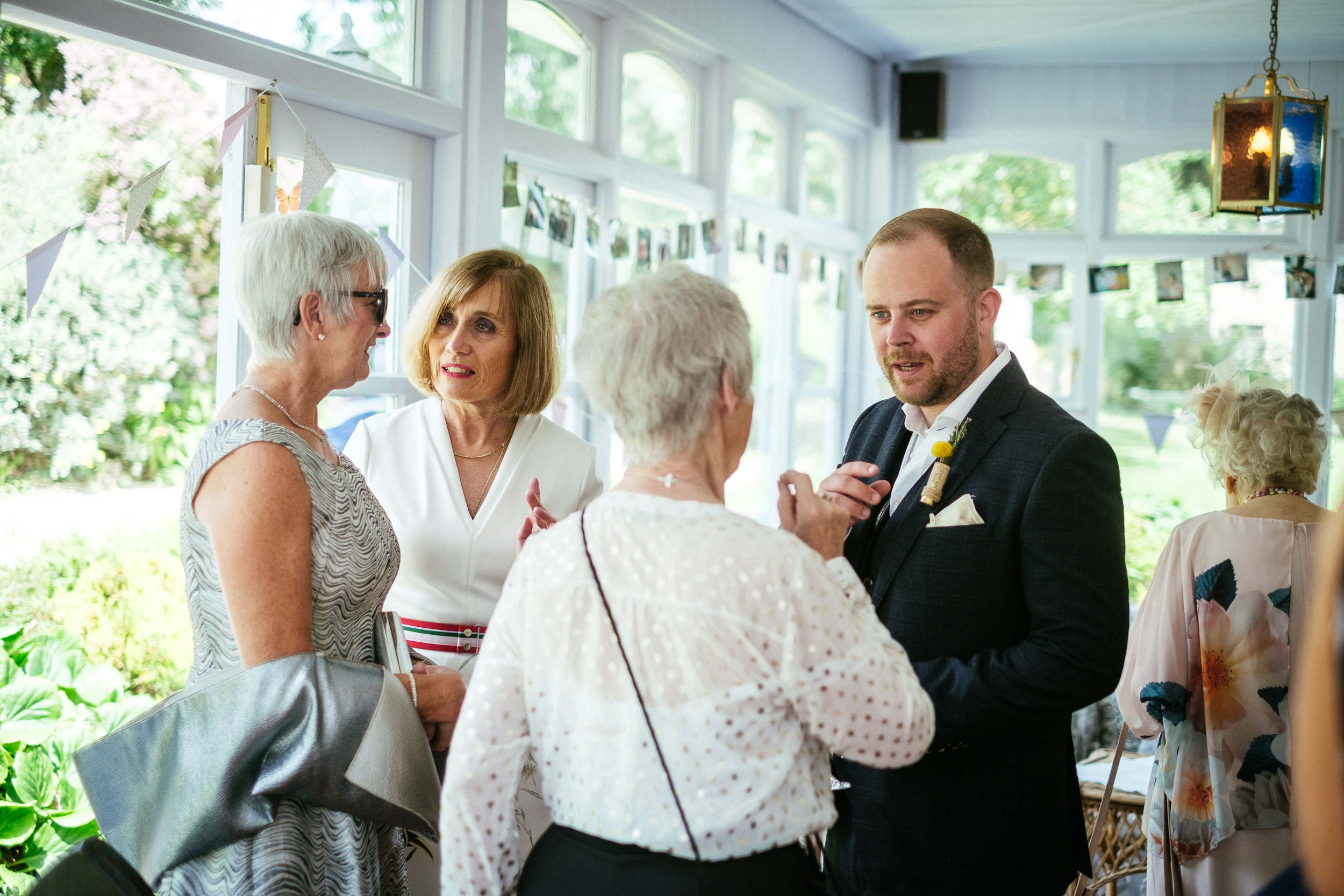 groom talking to wedding guests