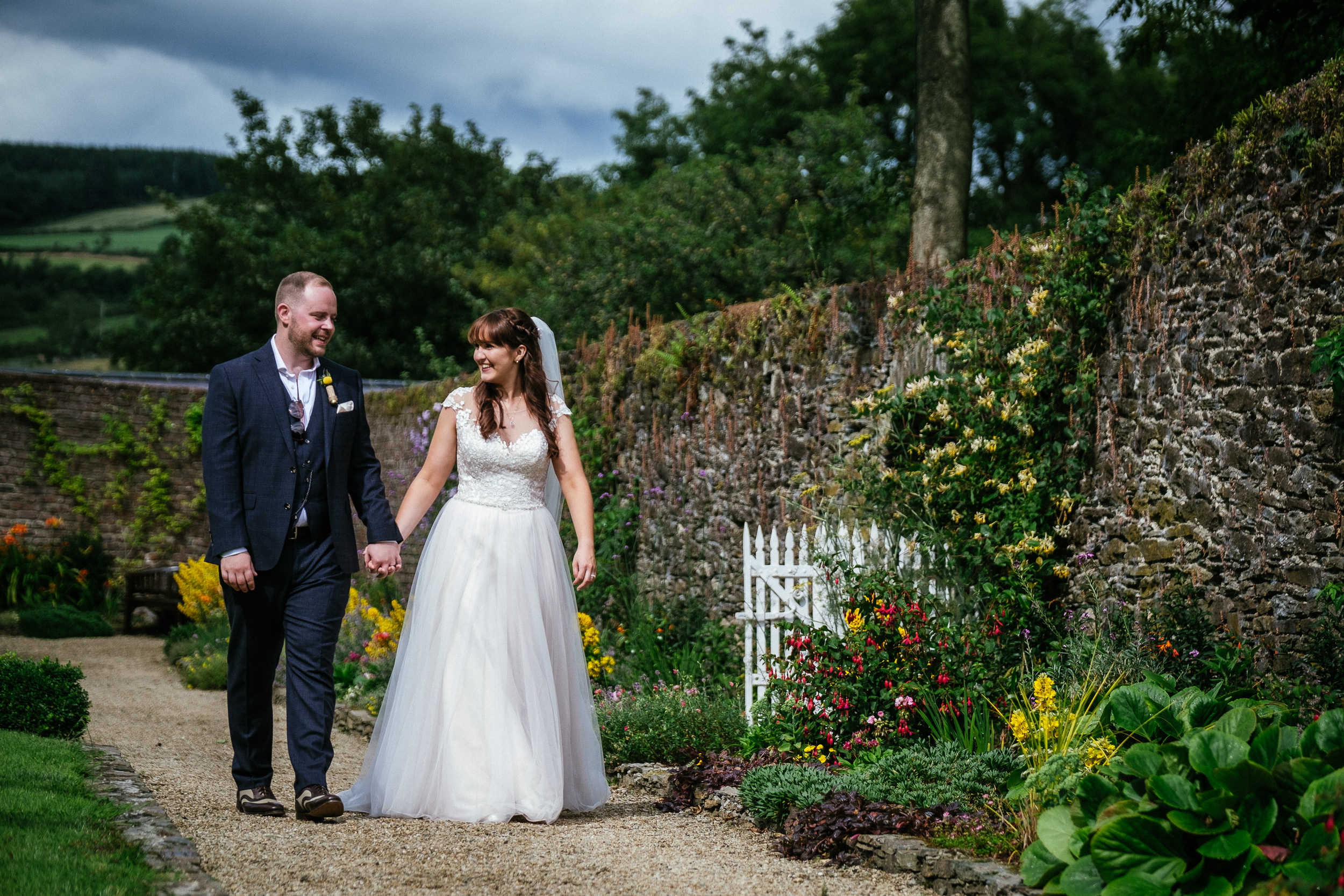 bride and groom walking in garden of ballybeg house