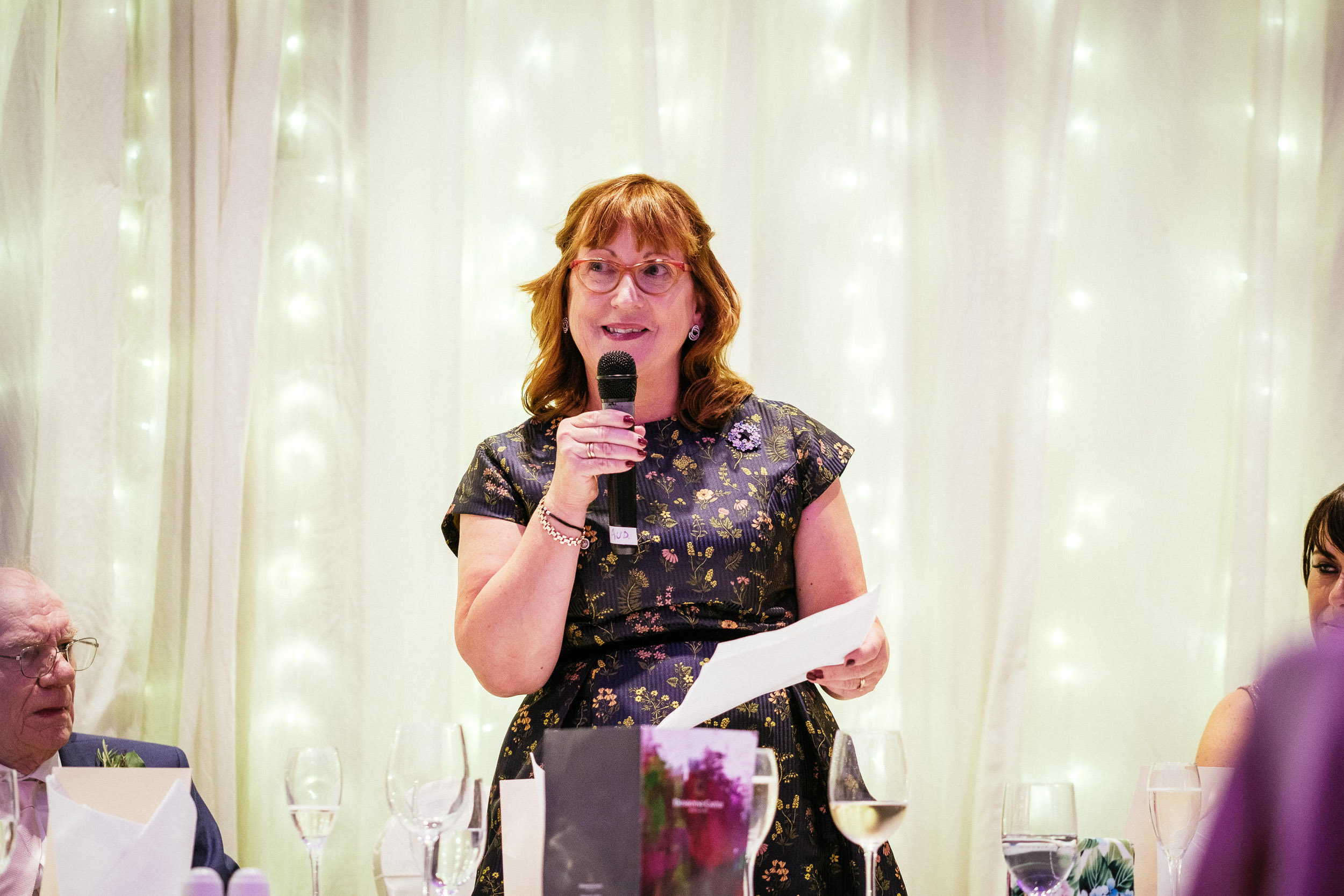 woman talking into a microphone during a wedding speech