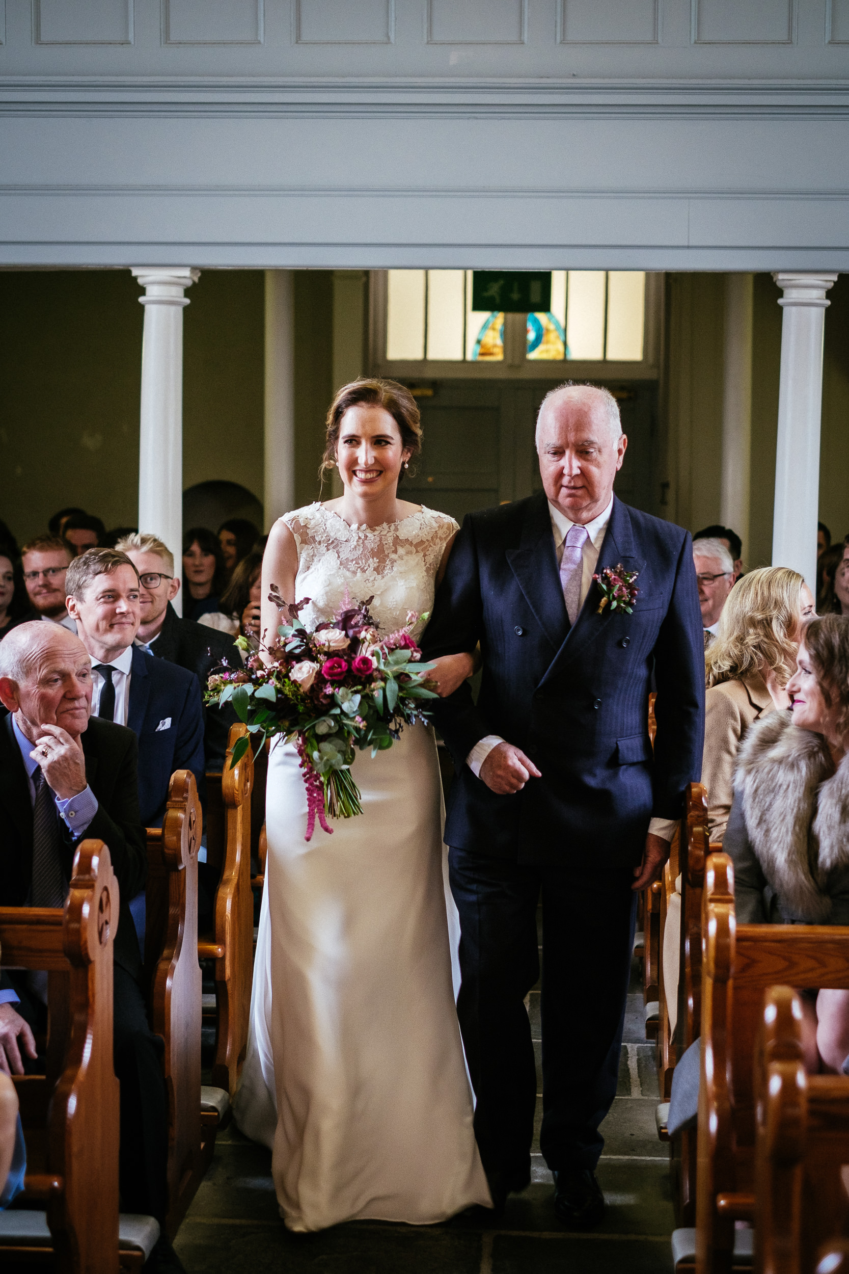bride walking with her dad down the church aisle