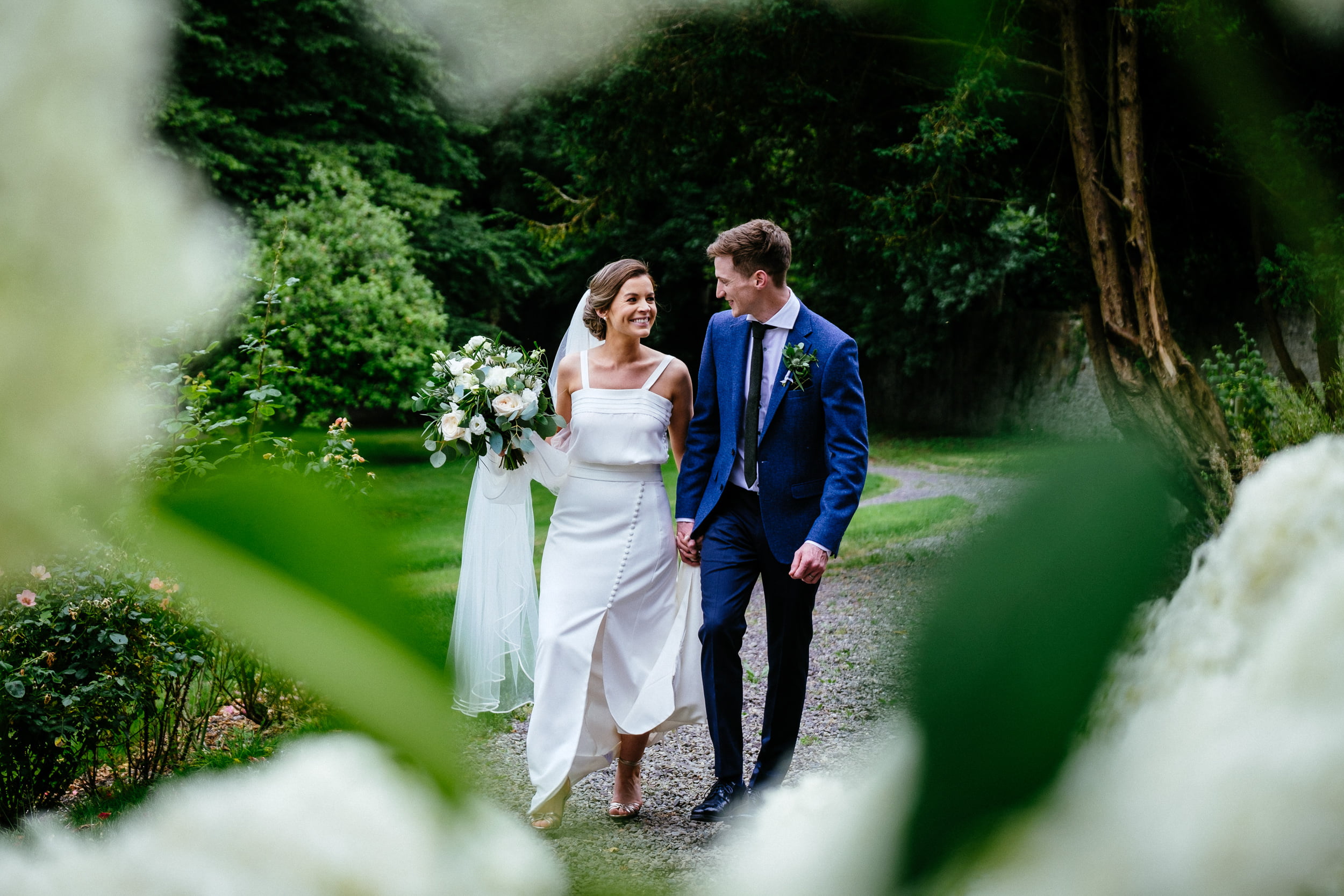 bride and groom walking in walled garden at their Boyne Hill House Wedding