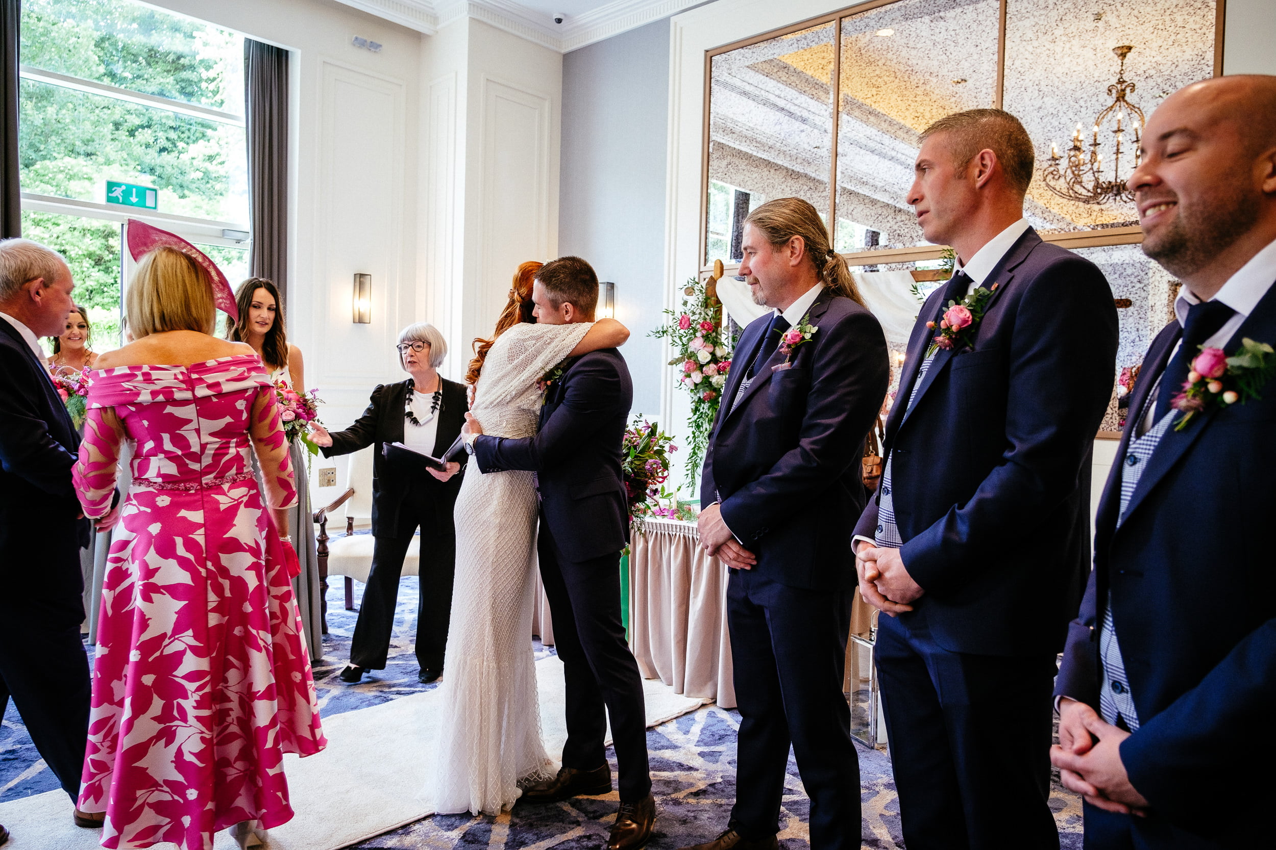groom greeting bride at their indoor civil wedding ceremony at the Fota Island Resort Cork
